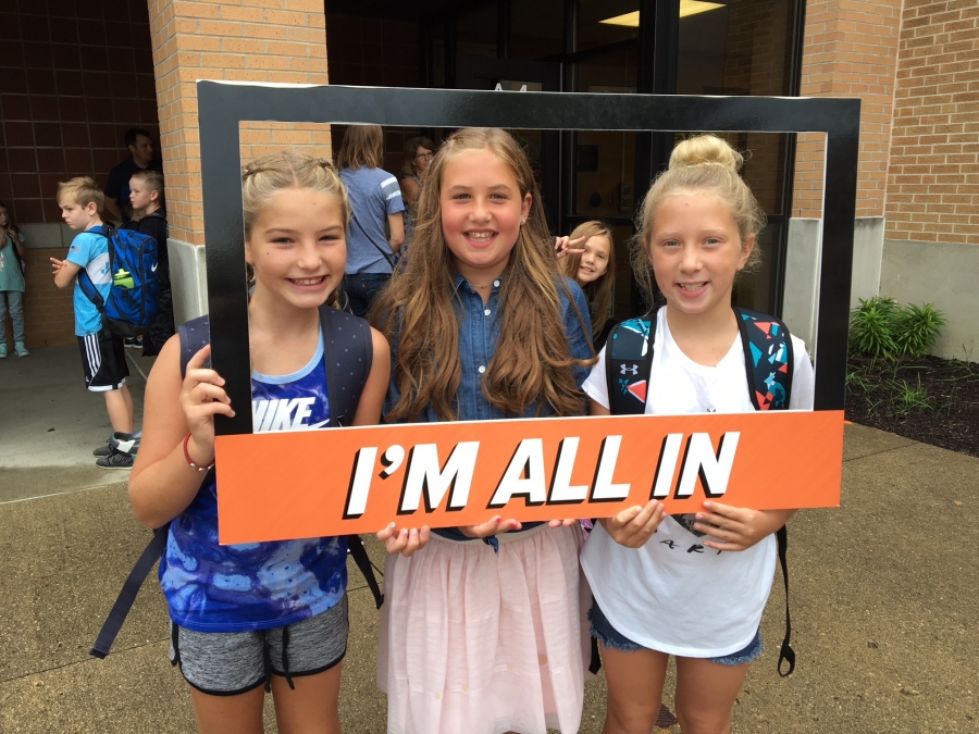 people holding a frame sign